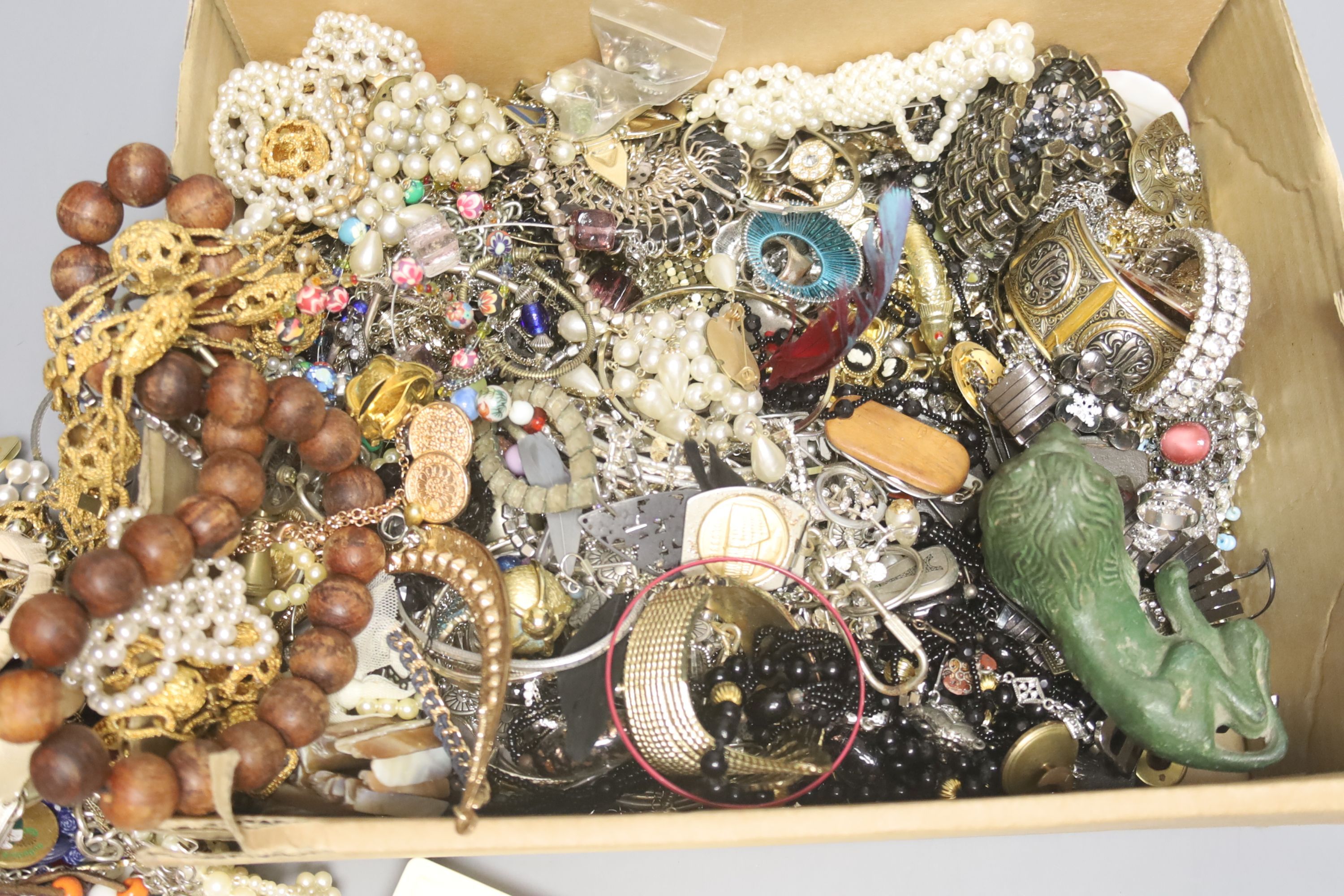 A large quantity of assorted costume jewellery and other items including antimony box and base metal figure of a lion.